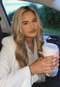 Victim Support volunteer Amina holding a cup of coffee