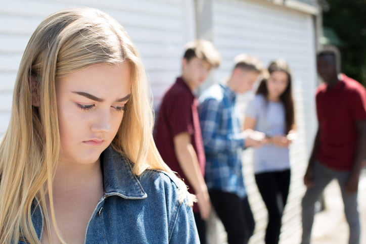 Girl being picked on by teenage friends