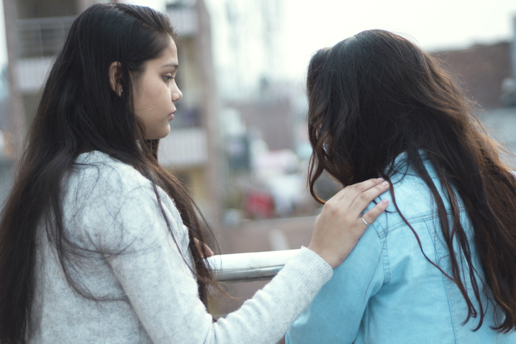 Two girls talking. One is comforting the other.