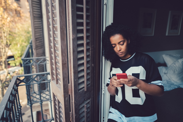 Young teenage girl using phone.