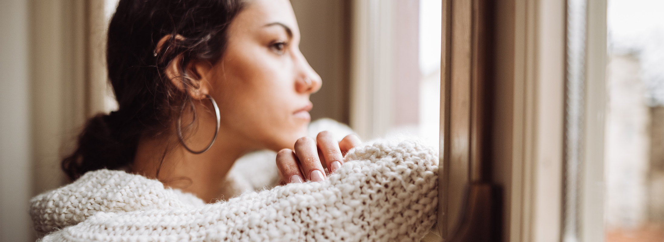 Woman looking out of window